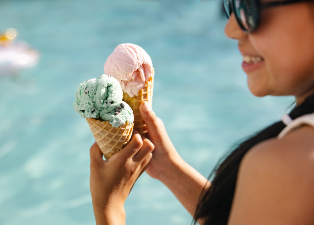 Girl holding ice cream cone by the pool at Sea Crest Beach Resort in Cape Cod