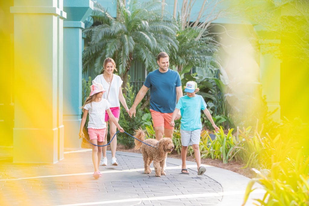 Family of four walking their dog around Hotel Landy in Orlando, Florida