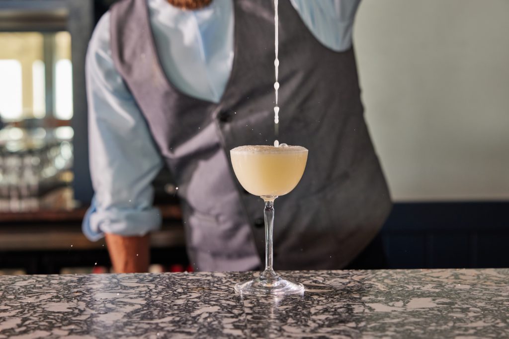 Bartender pouring cocktail into glass at Streetscape at Sea Crest Beach Resort in Cape Cod