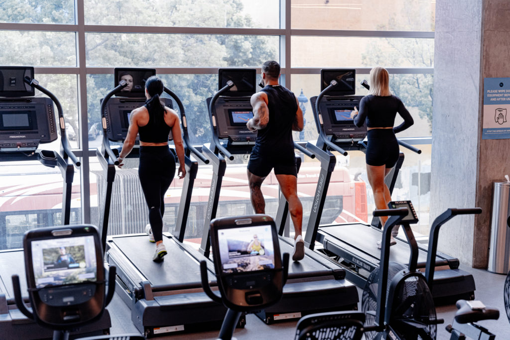 People on treadmills looking out window at FIT Athletic Club at Carte Hotel in San Diego